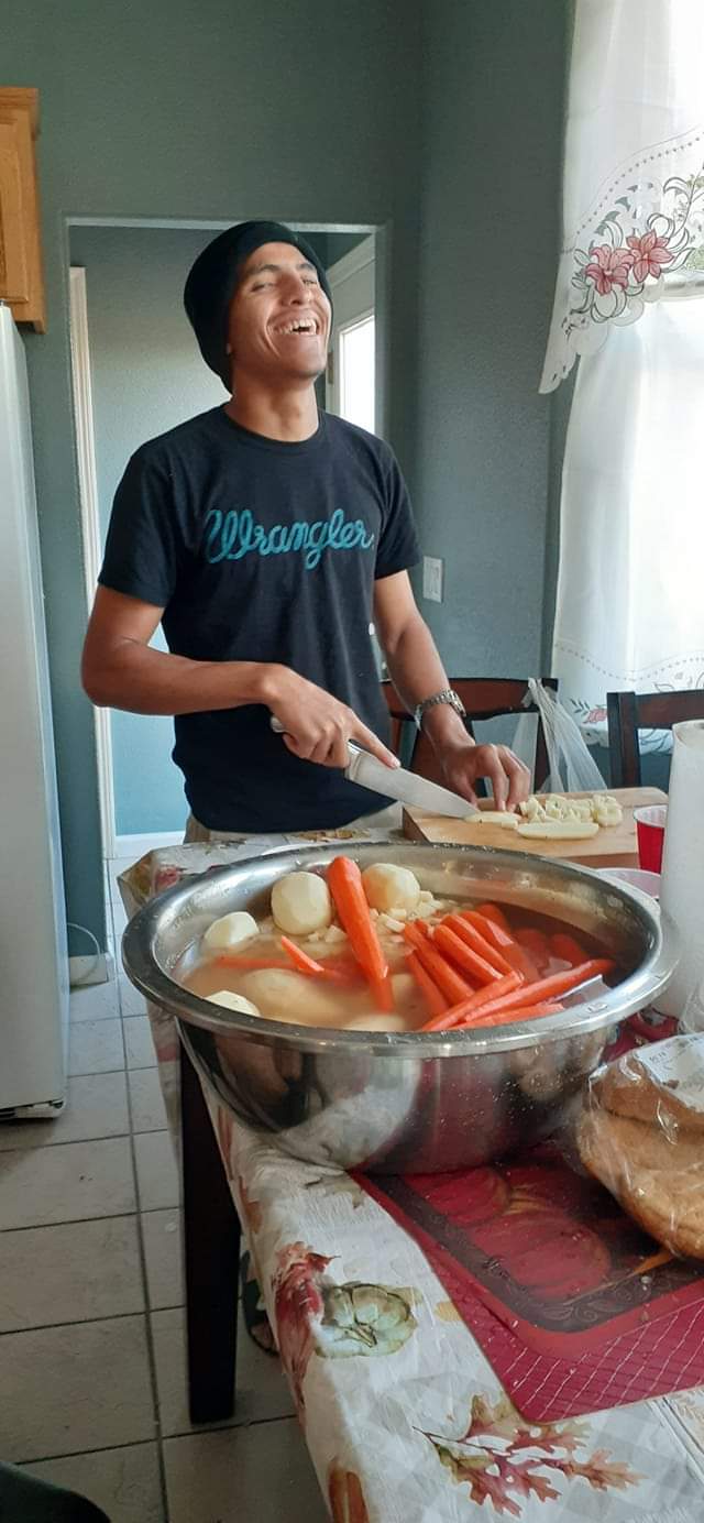 Jonathan Dominguez, founder and owner of The Great Landscape, smiling in his kitchen